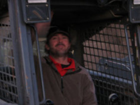 A picture of our staff member helping load landscape materials.
